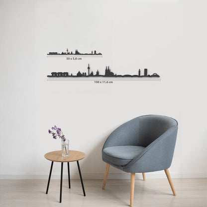 Comparativa de tamaños 50 cm y 100 cm de la silueta de Köln en una pared de salón.