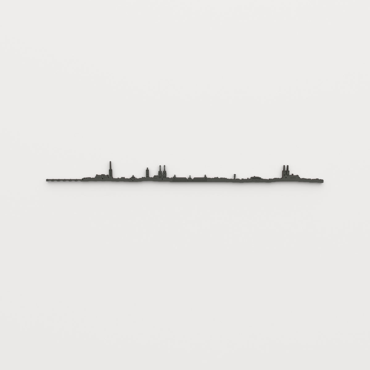 Vista frontal del skyline de Burdeos en madera, acabado negro, sobre pared clara.