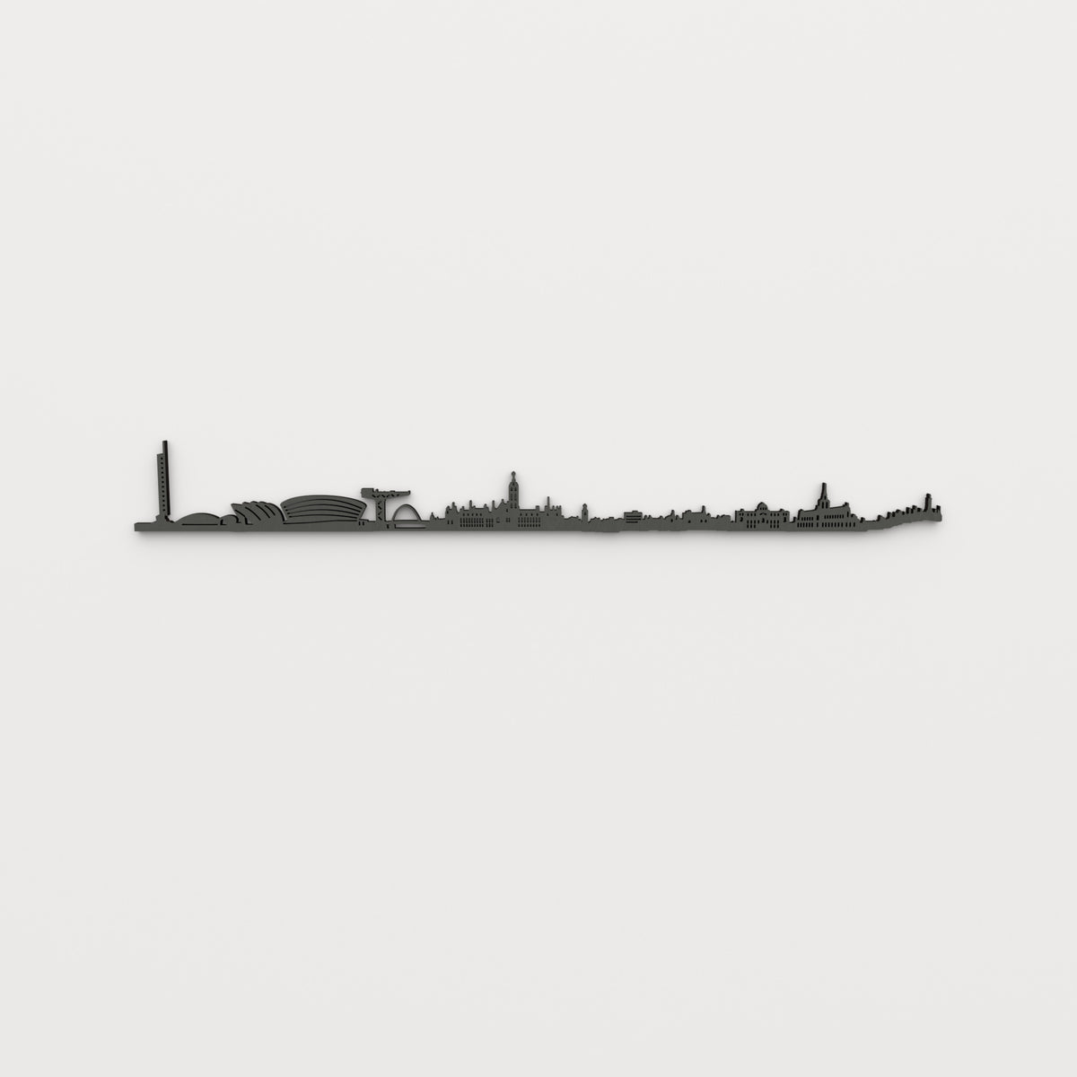 Vista frontal del skyline de Glasgow en acabado negro, con sus edificios y huecos recortados sobre pared clara.